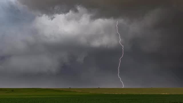 Lightning beside a rural pasture