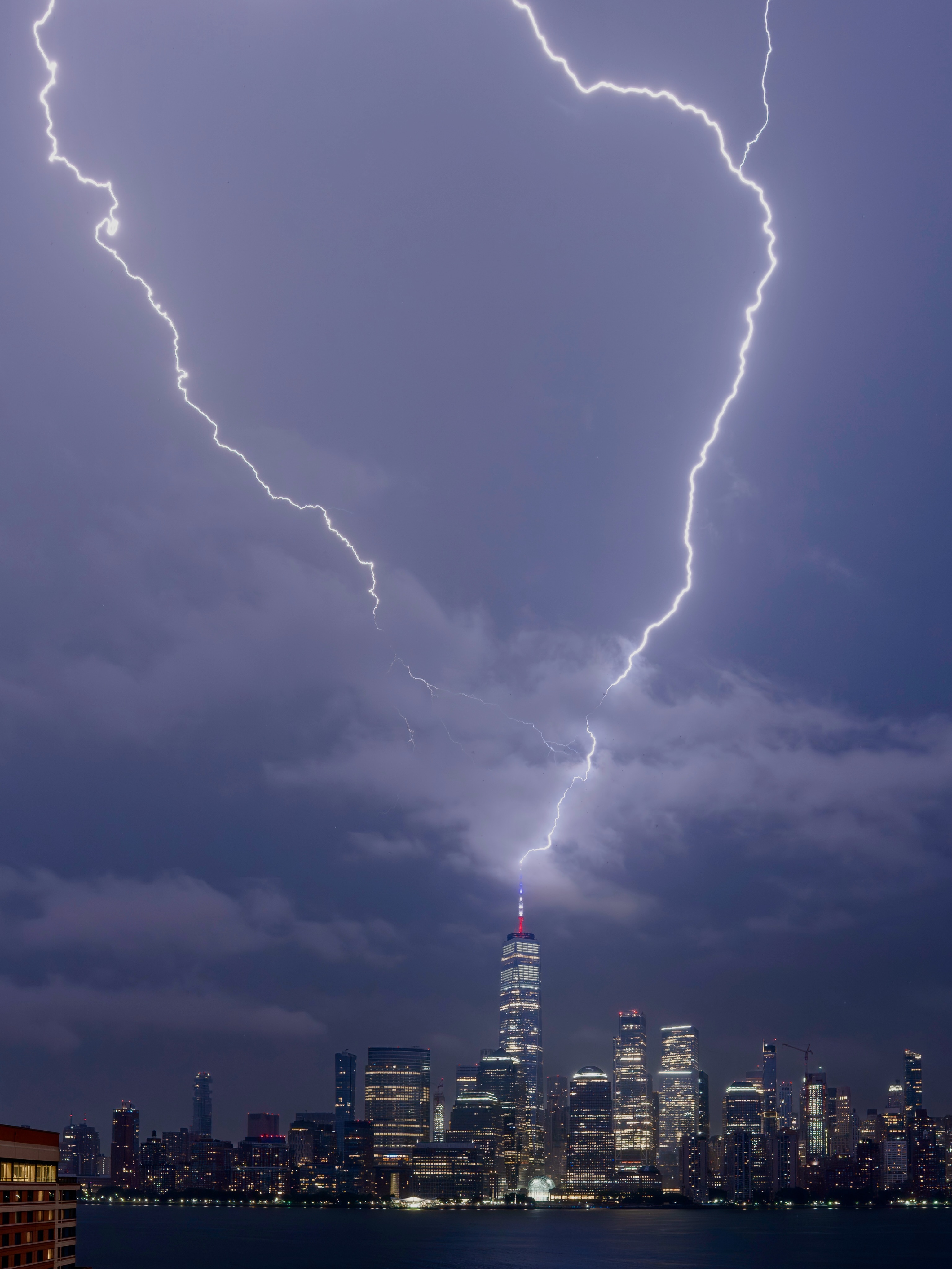 Lightning striking One World Trade Center above the skyline