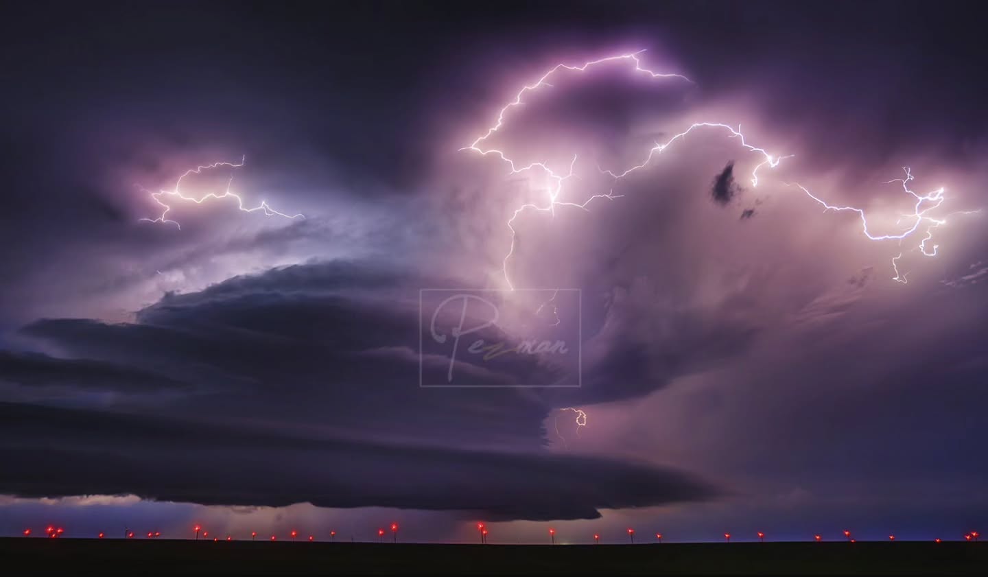Lightning illuminating a sculpted nighttime storm