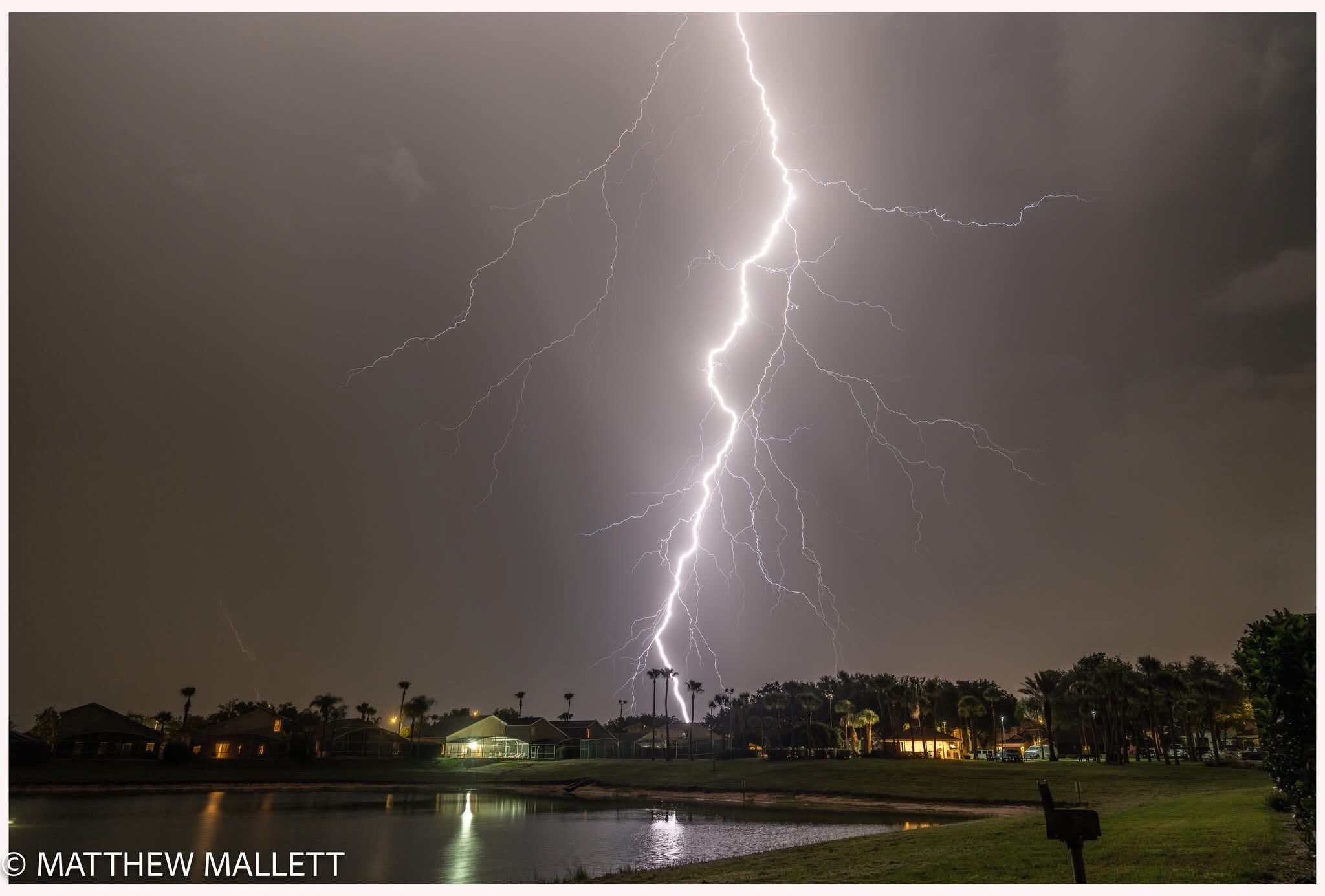 A bright lightning bolt reflected in a lake