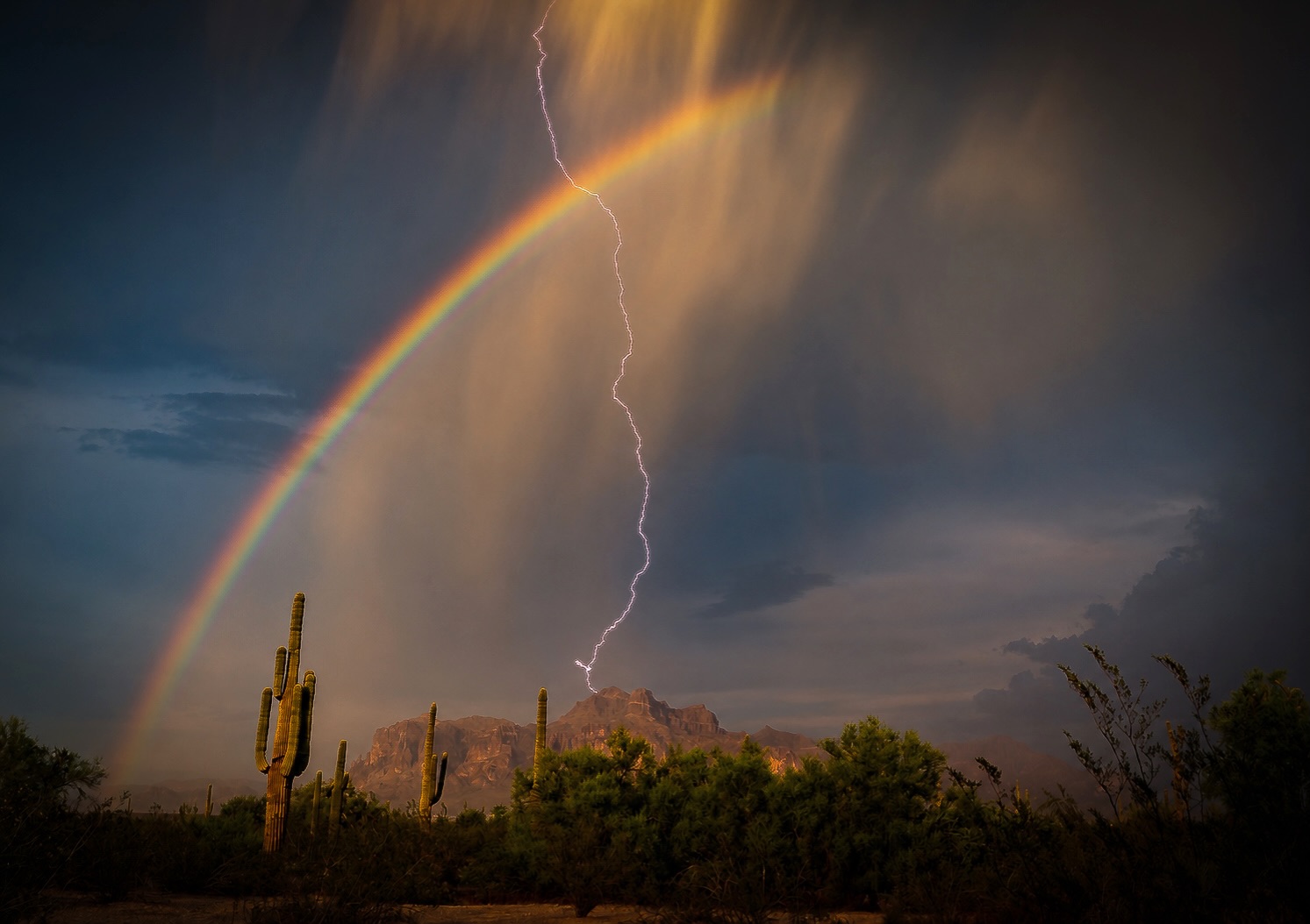 Rainbow and lightning near Flatiron in the Superstition Mountains