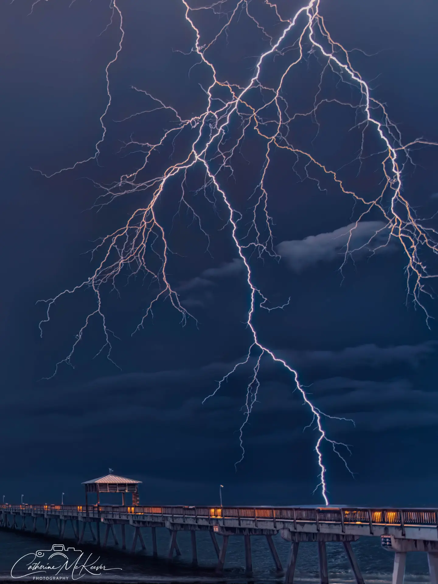 Branching lightning above a pier