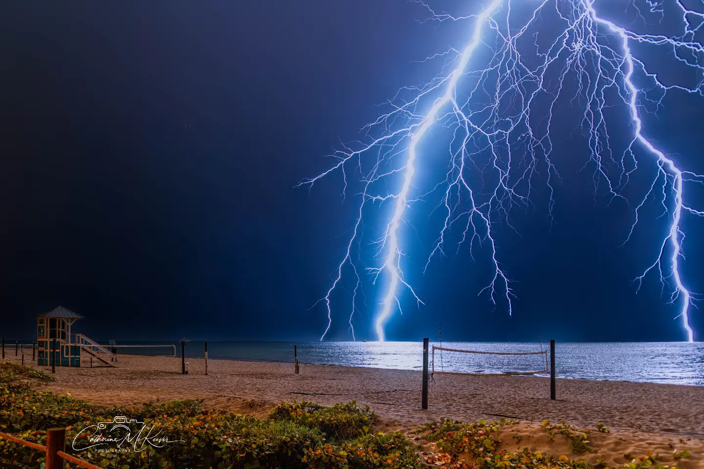 Branching lightning over a beach