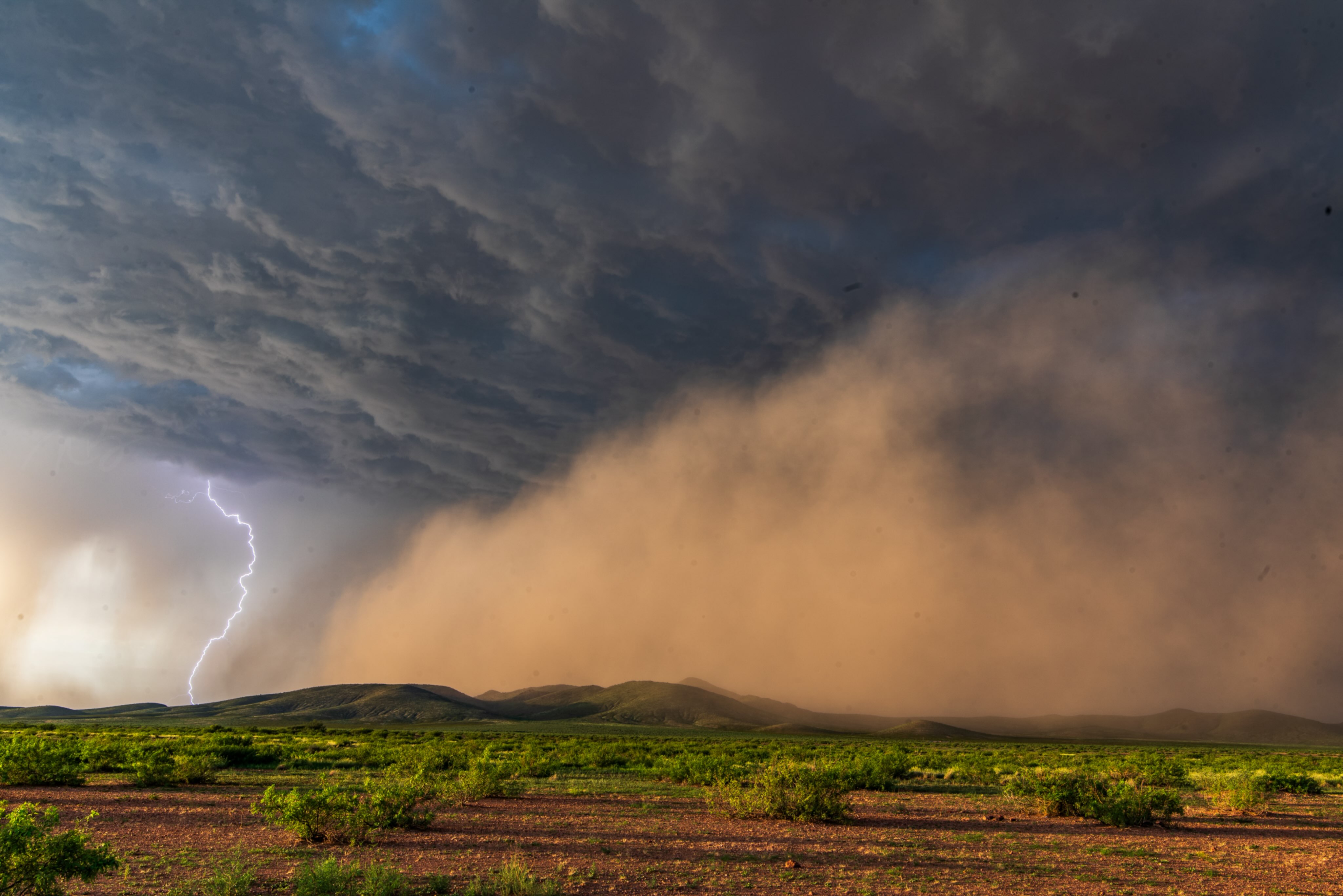 Lightning beside a sweeping dust storm