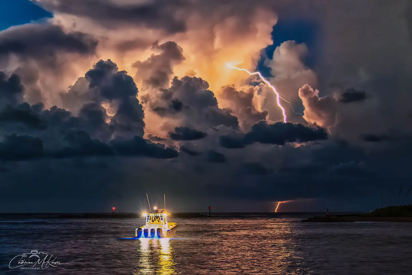 A fishing boat beneath a lightning storm